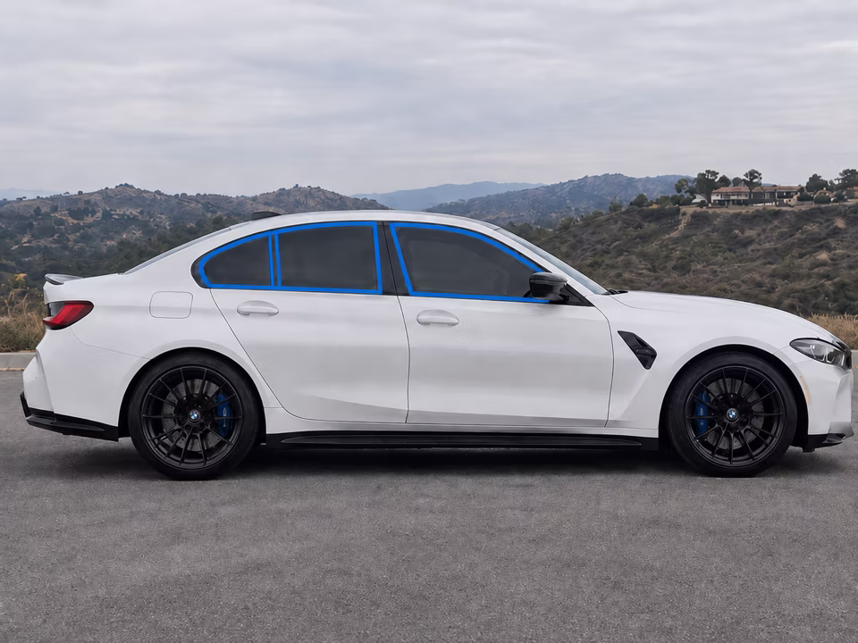 Passenger-side windows outlined in blue on a white sedan