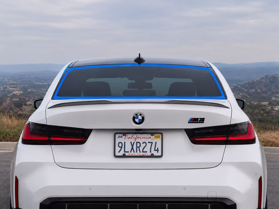 Rear window outlined in blue on a white BMW